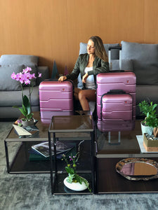 Rodez Luggage set rose gold in a living room with a female model